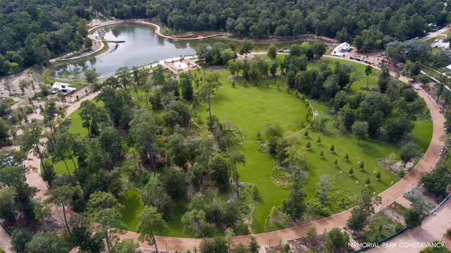 an aerial view of a house with a yard and lake view