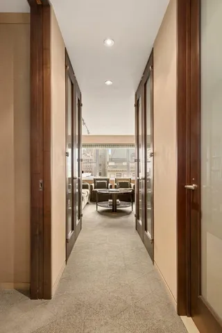 a view of a hallway with living room and furniture