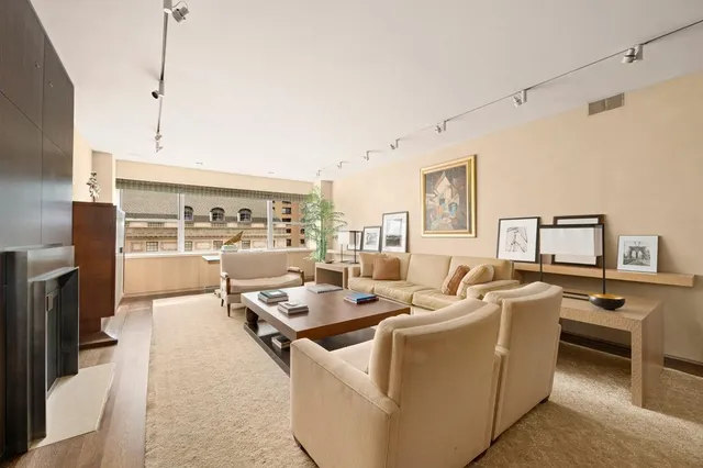 a living room with furniture gym equipment and a large window