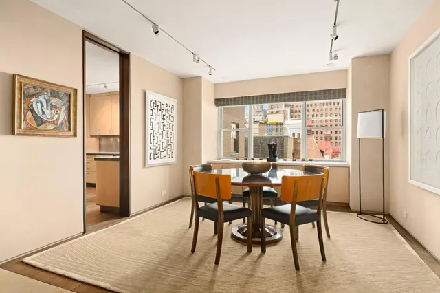 a dining room with furniture and window