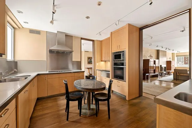 a kitchen with a table chairs refrigerator and cabinets