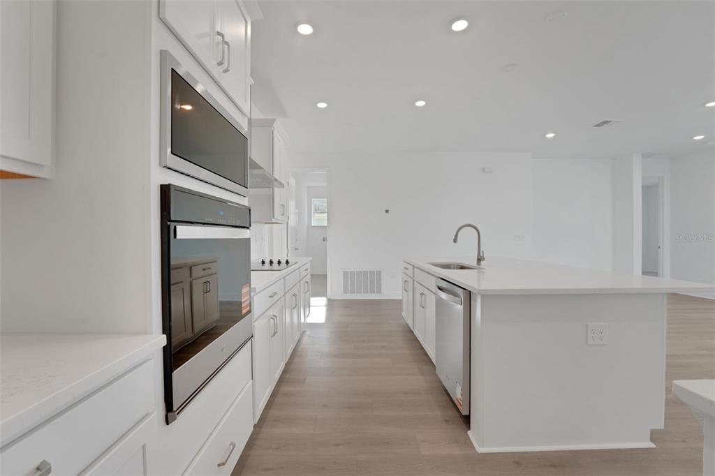 994 Fiesta Key Circle Lady Lake, FL 32159 - Photo 13 of 49 a kitchen with cabinets stainless steel appliances and a counter space