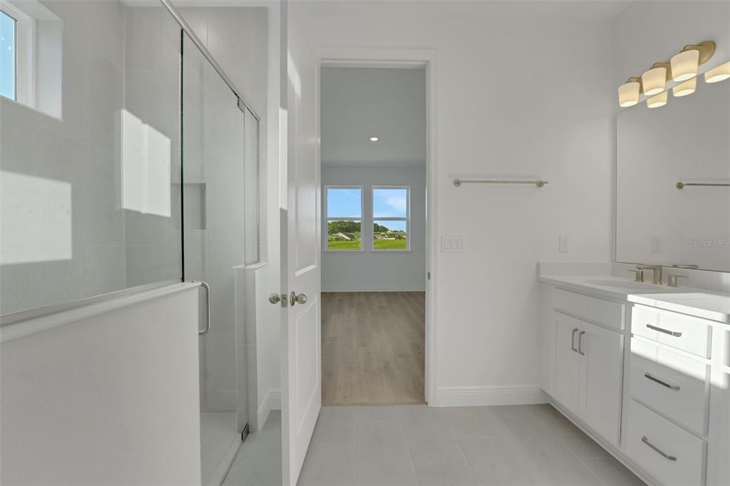 994 Fiesta Key Circle Lady Lake, FL 32159 - Photo 14 of 49 a bathroom with a granite countertop sink and a mirror