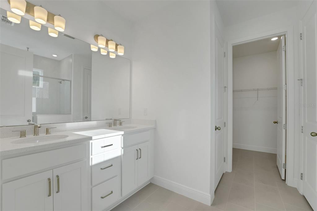 994 Fiesta Key Circle Lady Lake, FL 32159 - Photo 16 of 49 a bathroom with a sink a light fixture a vanity and a mirror