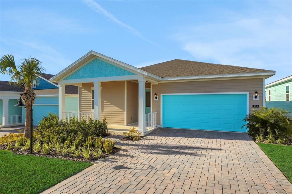 994 Fiesta Key Circle Lady Lake, FL 32159 - Photo 2 of 49 a front view of a house with a yard and garage