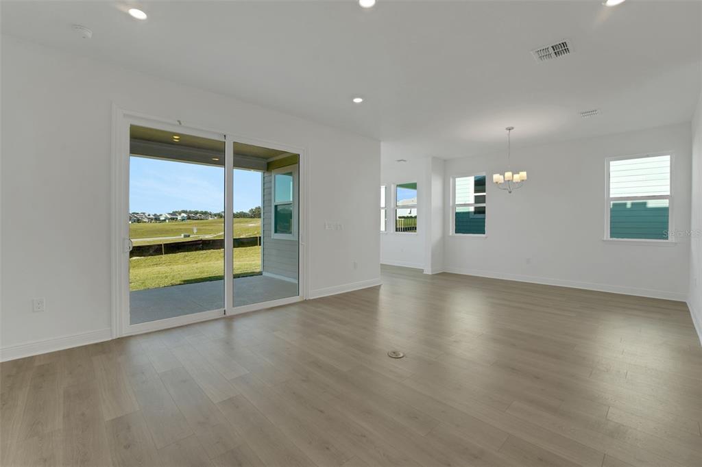 994 Fiesta Key Circle Lady Lake, FL 32159 - Photo 21 of 49 an empty room with wooden floor and windows