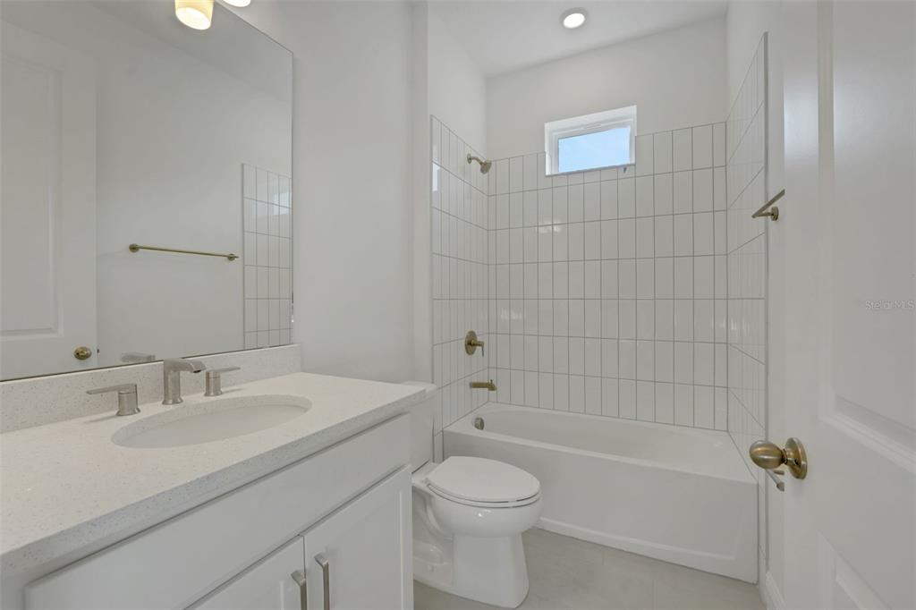 994 Fiesta Key Circle Lady Lake, FL 32159 - Photo 25 of 49 a bathroom with a sink a toilet and shower