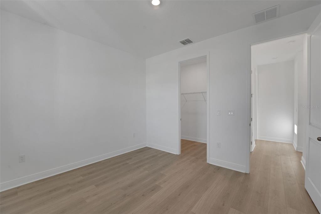 994 Fiesta Key Circle Lady Lake, FL 32159 - Photo 27 of 49 a view of a room with wooden floor