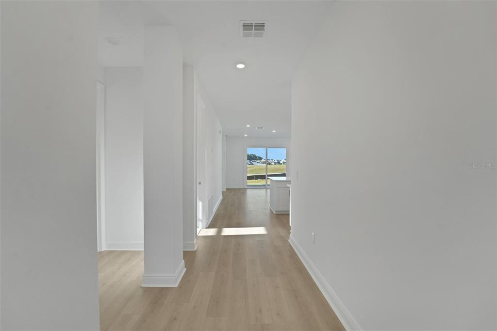994 Fiesta Key Circle Lady Lake, FL 32159 - Photo 31 of 49 a view of a hallway with wooden floor
