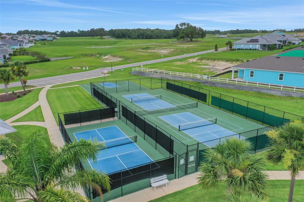 994 Fiesta Key Circle Lady Lake, FL 32159 - Photo 45 of 49 a view of a lush green field with sitting area