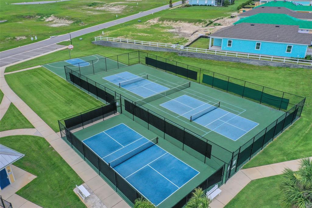 994 Fiesta Key Circle Lady Lake, FL 32159 - Photo 46 of 49 a view of a tennis ground with a big yard