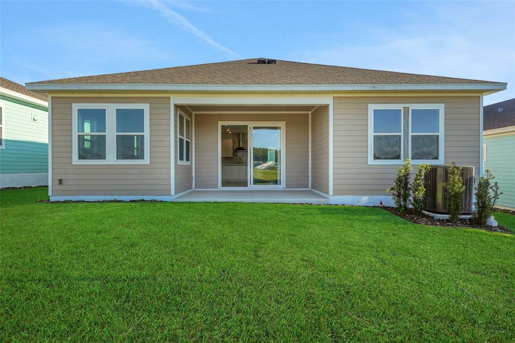 994 Fiesta Key Circle Lady Lake, FL 32159 - Photo 7 of 49 front view of a house with a yard