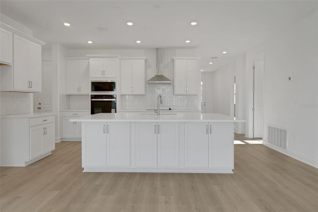 994 Fiesta Key Circle Lady Lake, FL 32159 - Photo 10 of 49 a view of kitchen with wooden floor