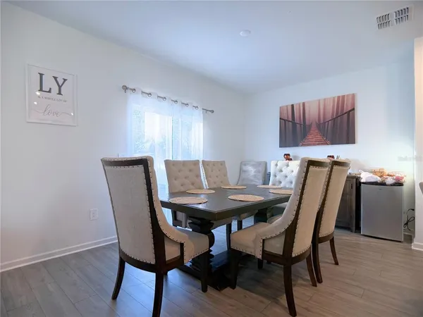 a view of a dining room with furniture and wooden floor