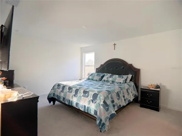 a bedroom with a bed and a dresser