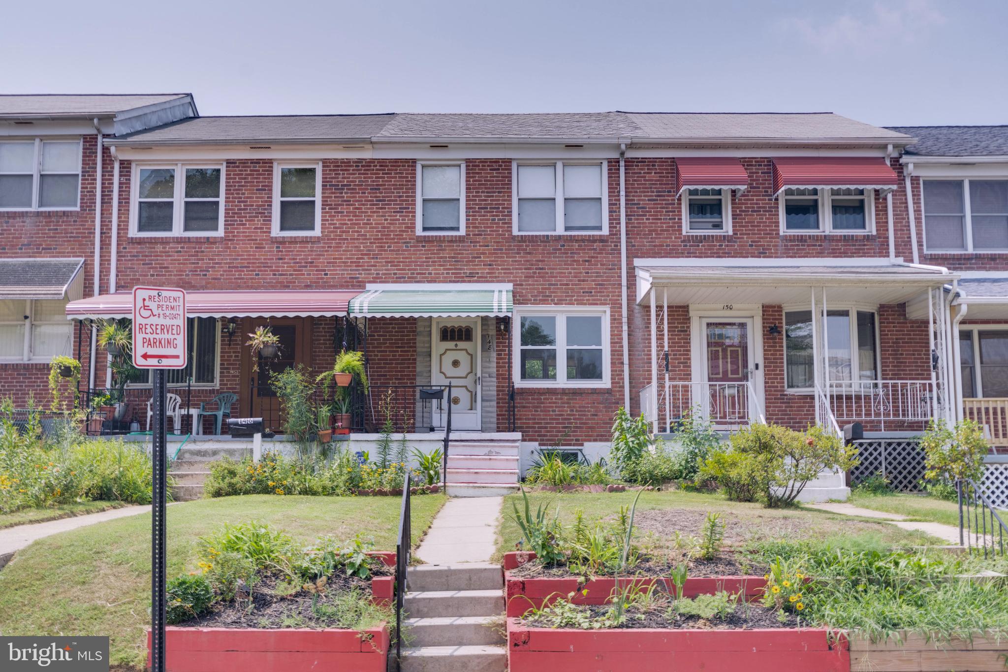 148 Wiltshire Road Baltimore, MD 21221 - Photo 1 of 28 front view of a brick house with a yard