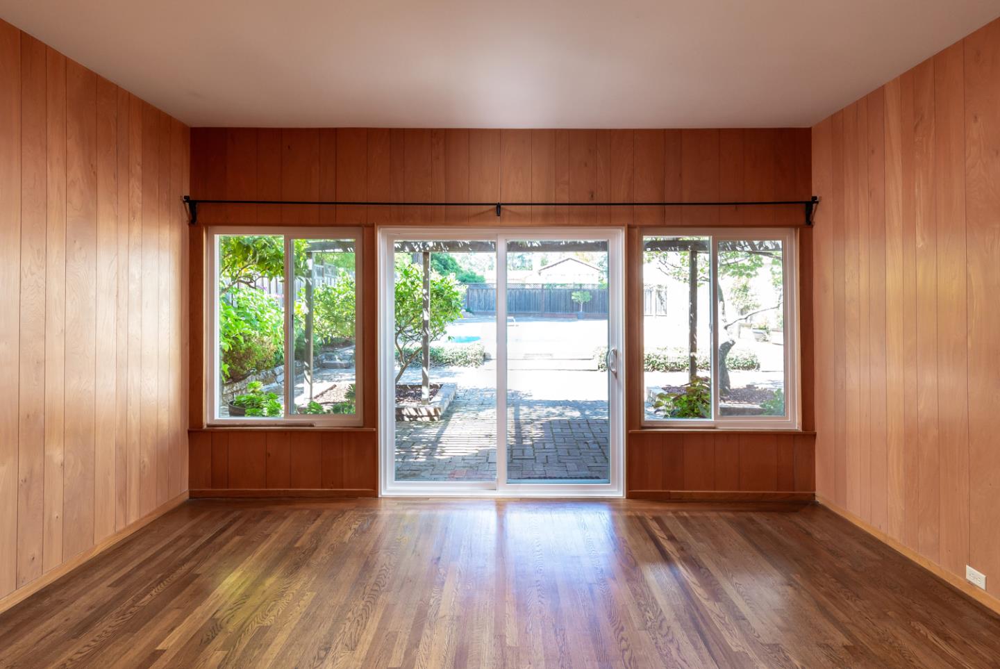 425 Hillcrest Road San Mateo, CA 94402 - Photo 17 of 48 an empty room with wooden floor and windows