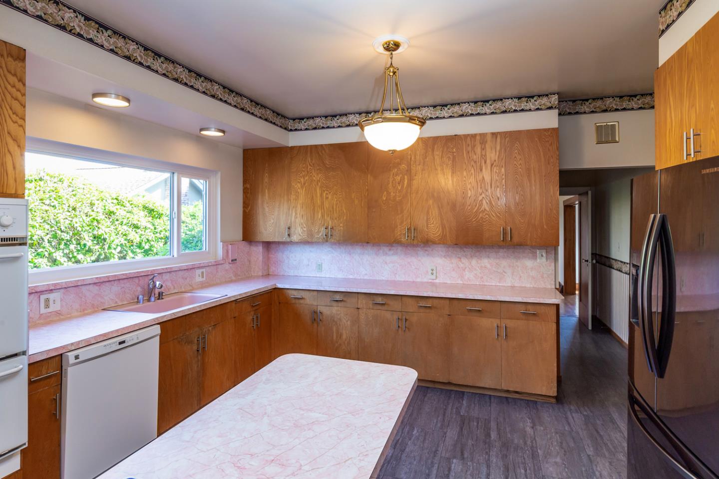 425 Hillcrest Road San Mateo, CA 94402 - Photo 20 of 48 a kitchen with a wooden floor and a window
