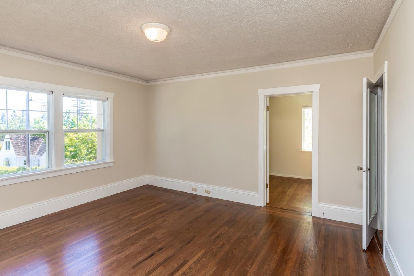 425 Hillcrest Road San Mateo, CA 94402 - Photo 28 of 48 an empty room with wooden floor and windows