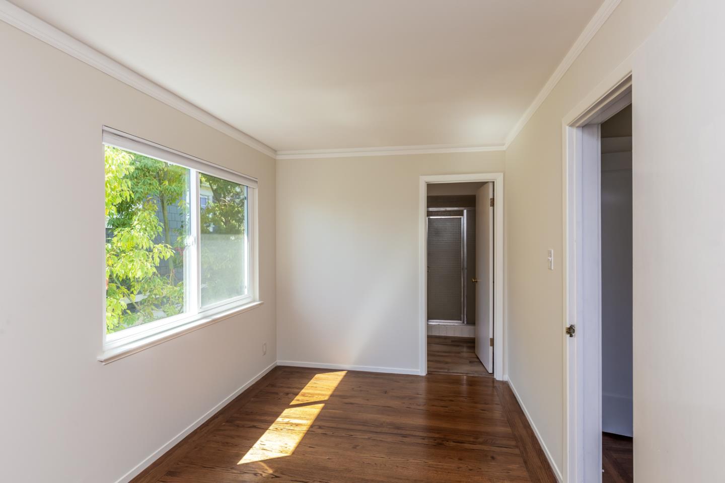 425 Hillcrest Road San Mateo, CA 94402 - Photo 29 of 48 a view of a hallway with wooden floor and a window