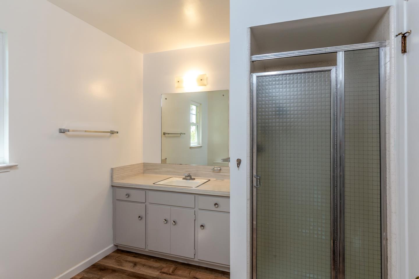 425 Hillcrest Road San Mateo, CA 94402 - Photo 33 of 48 a spacious bathroom with a granite countertop sink a mirror and a