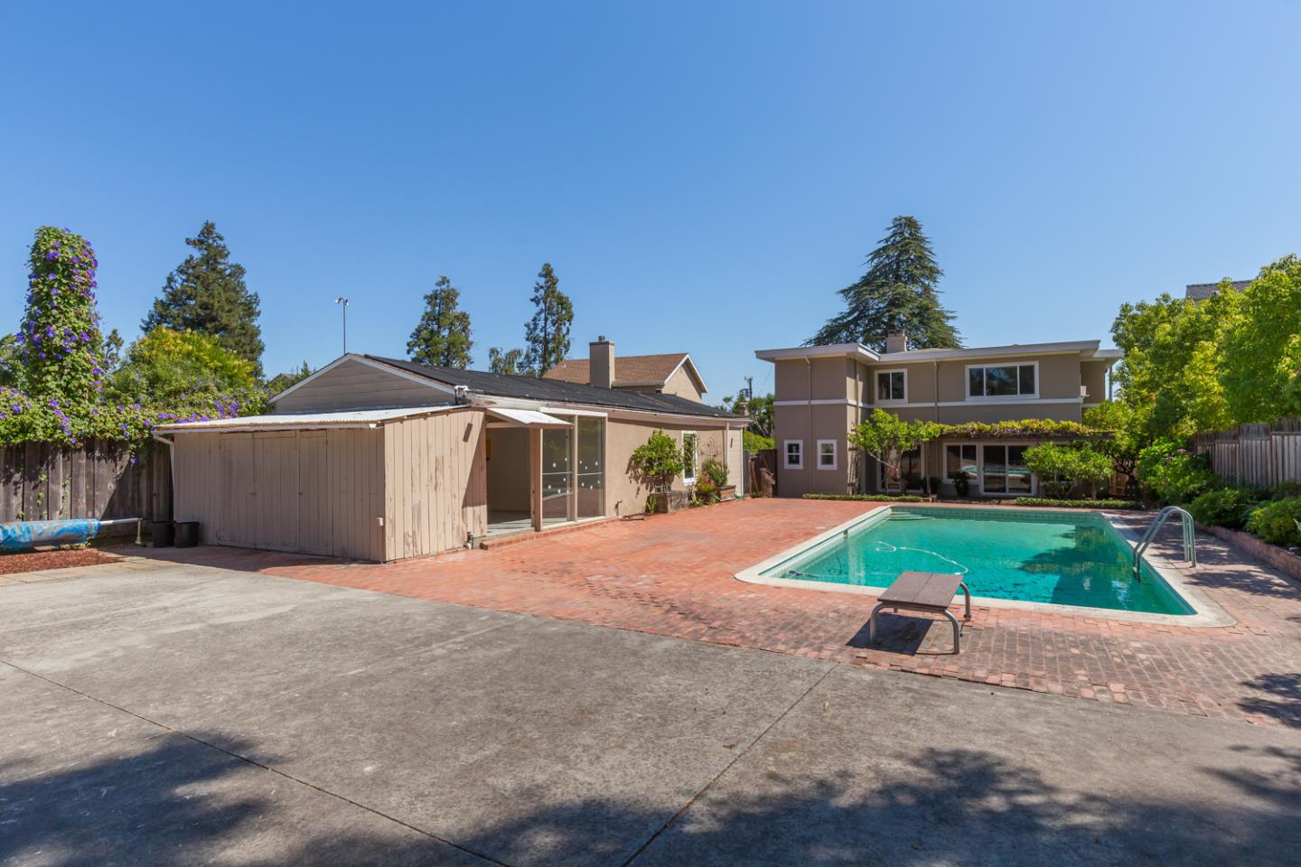 425 Hillcrest Road San Mateo, CA 94402 - Photo 8 of 48 a front view of a house with a yard and garage
