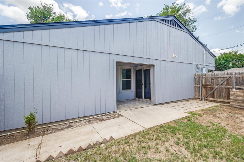3326 Gardenview Circle Denton, TX 76207 - Photo 12 of 13 a backyard of a house with potted plants and covered with wooden fence