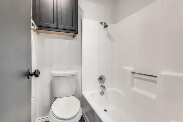 a white toilet sitting next to a bathroom sink