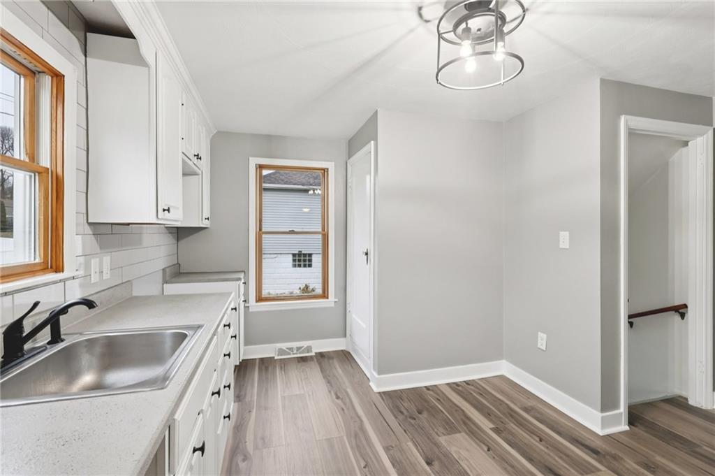 380 James Street Springdale, PA 15144 - Photo 11 of 34 a kitchen that has a sink cabinets and wooden floor