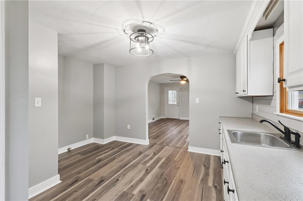 380 James Street Springdale, PA 15144 - Photo 12 of 34 a view of a kitchen with wooden floor and cabinets