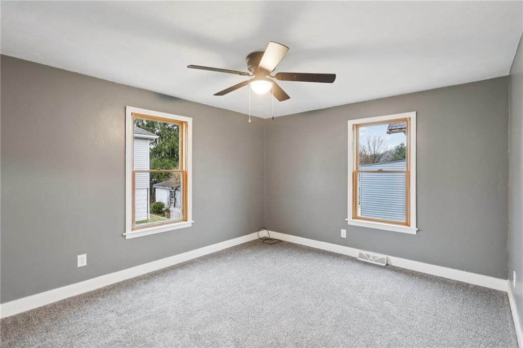 380 James Street Springdale, PA 15144 - Photo 14 of 34 an empty room with windows and fan