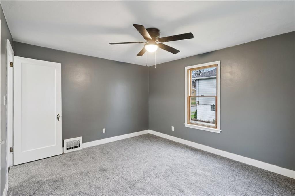 380 James Street Springdale, PA 15144 - Photo 16 of 34 an empty room with windows and fan