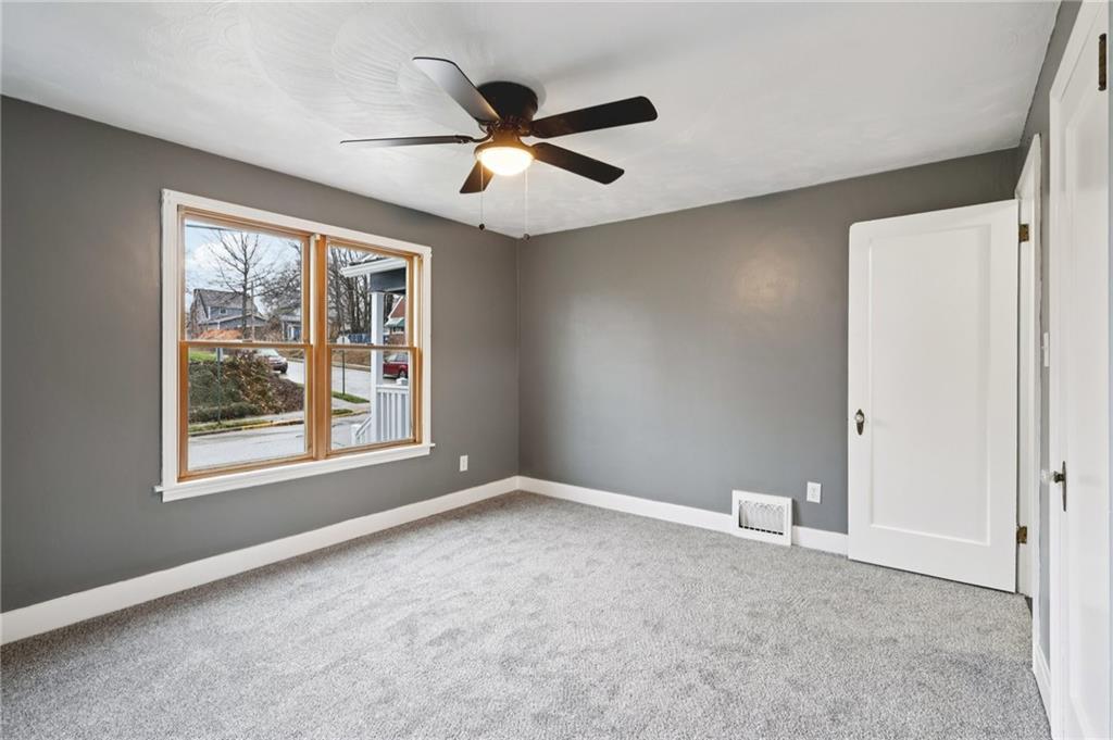 380 James Street Springdale, PA 15144 - Photo 23 of 34 an empty room with windows and fan