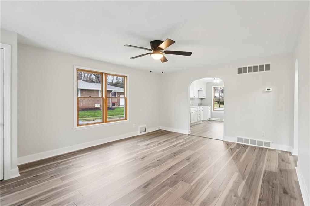 380 James Street Springdale, PA 15144 - Photo 7 of 34 a view of empty room with wooden floor and fan