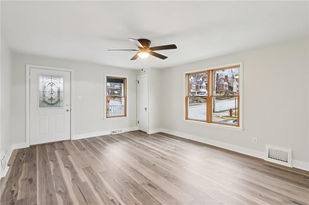 380 James Street Springdale, PA 15144 - Photo 8 of 34 a view of empty room with wooden floor and fan