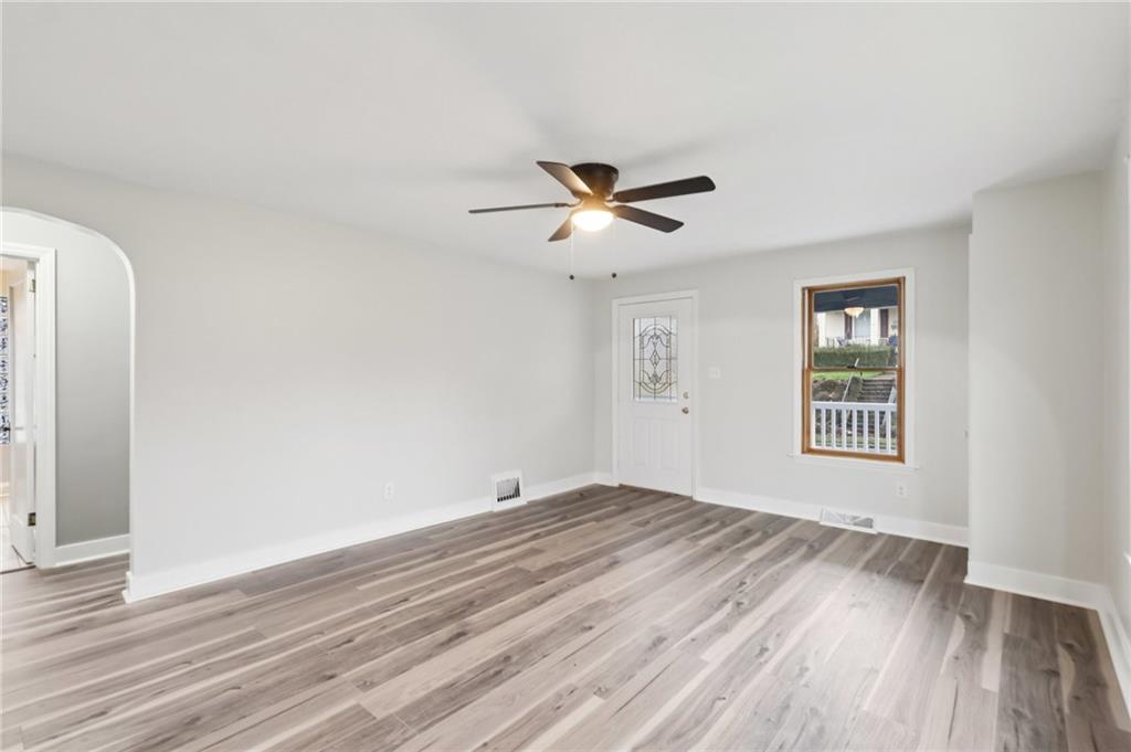 380 James Street Springdale, PA 15144 - Photo 9 of 34 a view of a room with wooden floor and a ceiling fan