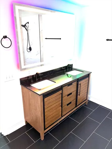 a bath room with a sink and a mirror