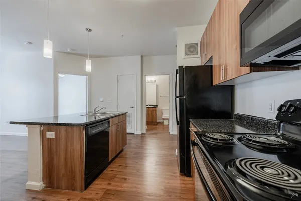 a kitchen with stainless steel appliances granite countertop a stove and a refrigerator