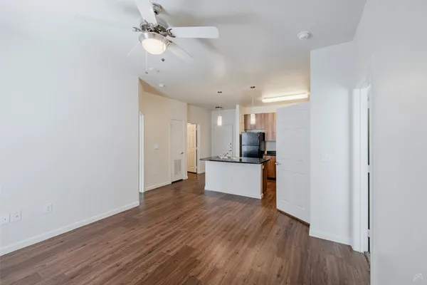 a view of a kitchen with wooden floor and a kitchen