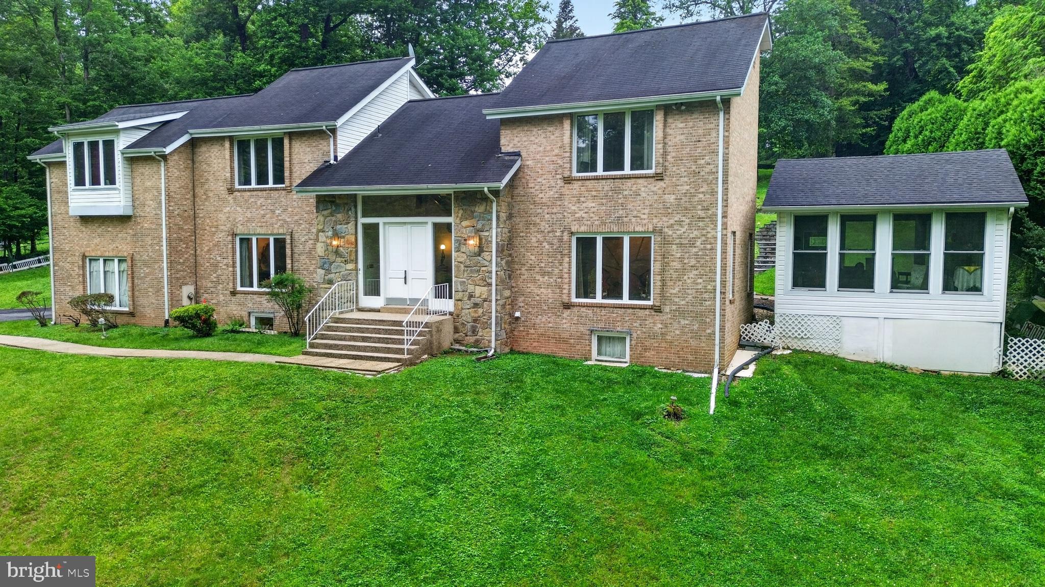 10320 Glen Road Potomac, MD 20854 - Photo 33 of 75 a front view of a house with a garden