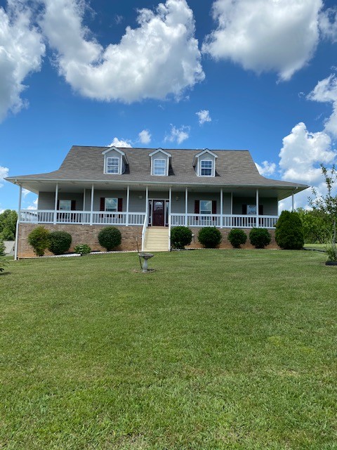 a front view of a building with a garden and plants