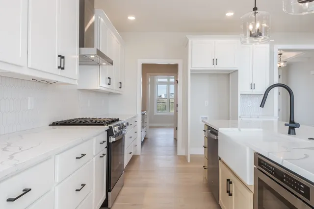 a kitchen with a sink stove and cabinets