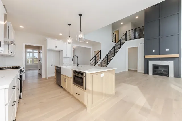 a kitchen with stove a sink and a refrigerator