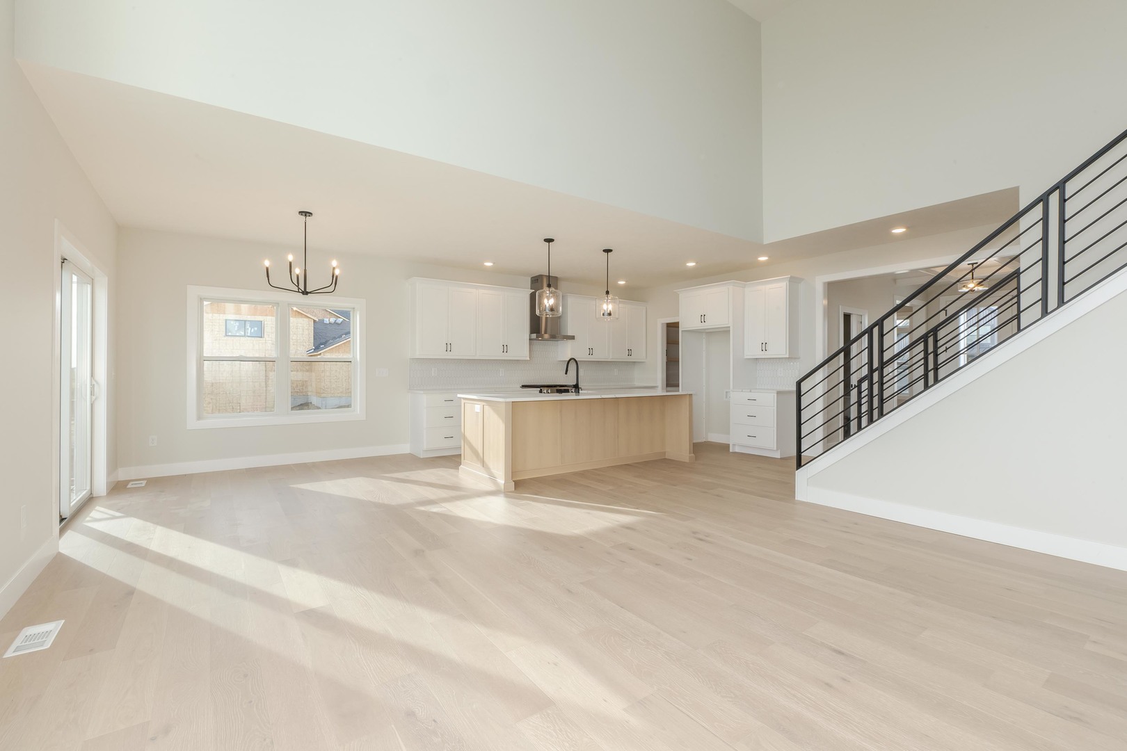 1004 Mount Carmel Road Bloomington, IL 61705 - Photo 13 of 44 a view of a kitchen with wooden floor and windows