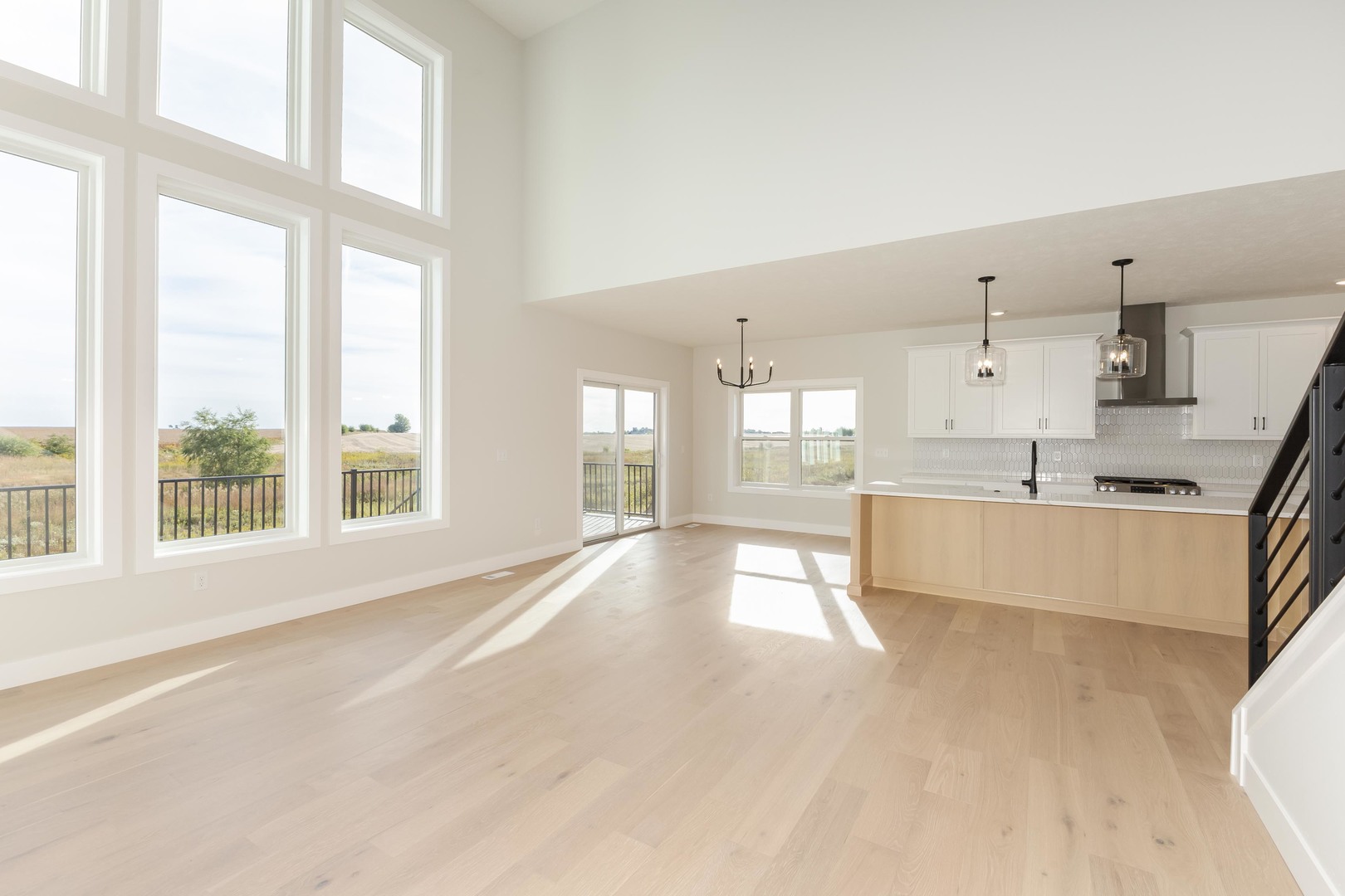 1004 Mount Carmel Road Bloomington, IL 61705 - Photo 17 of 44 a large white kitchen with granite countertop a large window and a sink