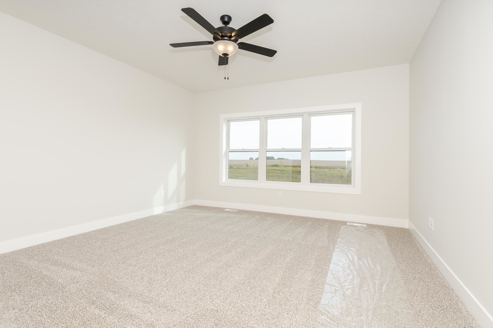1004 Mount Carmel Road Bloomington, IL 61705 - Photo 21 of 44 an empty room with a window and a fan