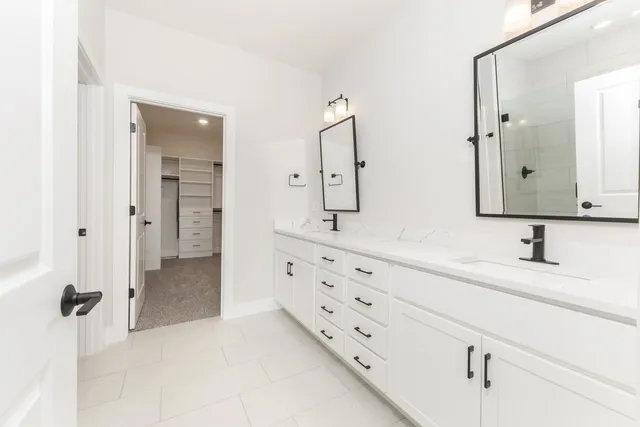 a bathroom with a double vanity sink mirror and double