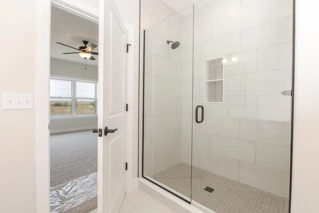 a bathroom with a glass shower door