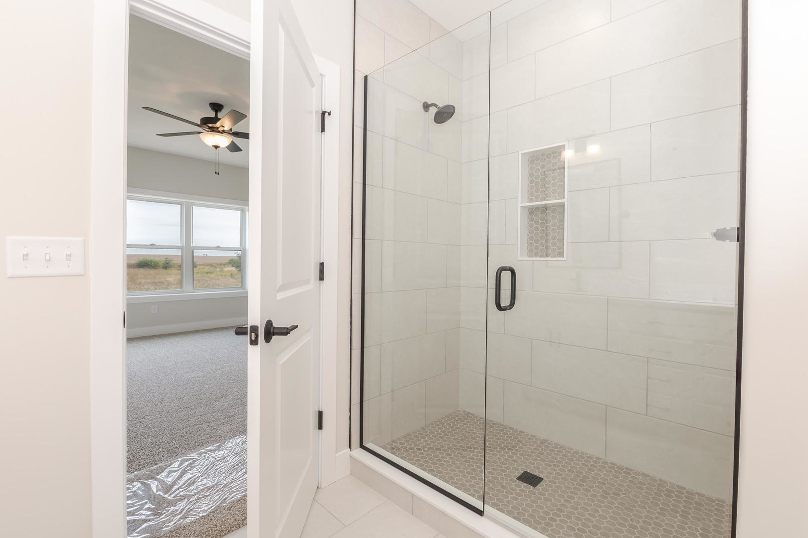 1004 Mount Carmel Road Bloomington, IL 61705 - Photo 24 of 44 a bathroom with a glass shower door