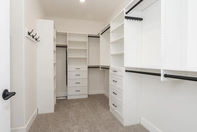 a view of walk in closet with empty racks